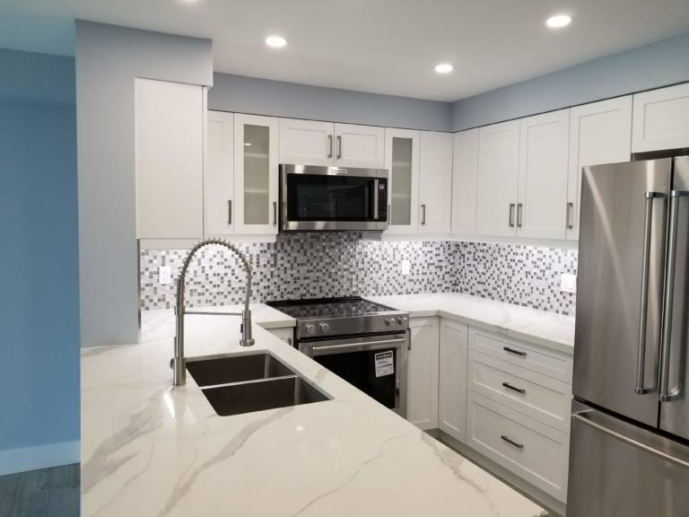 amazing small kitchen with build in appliance and back lit white cabinets - remodeling kitchen