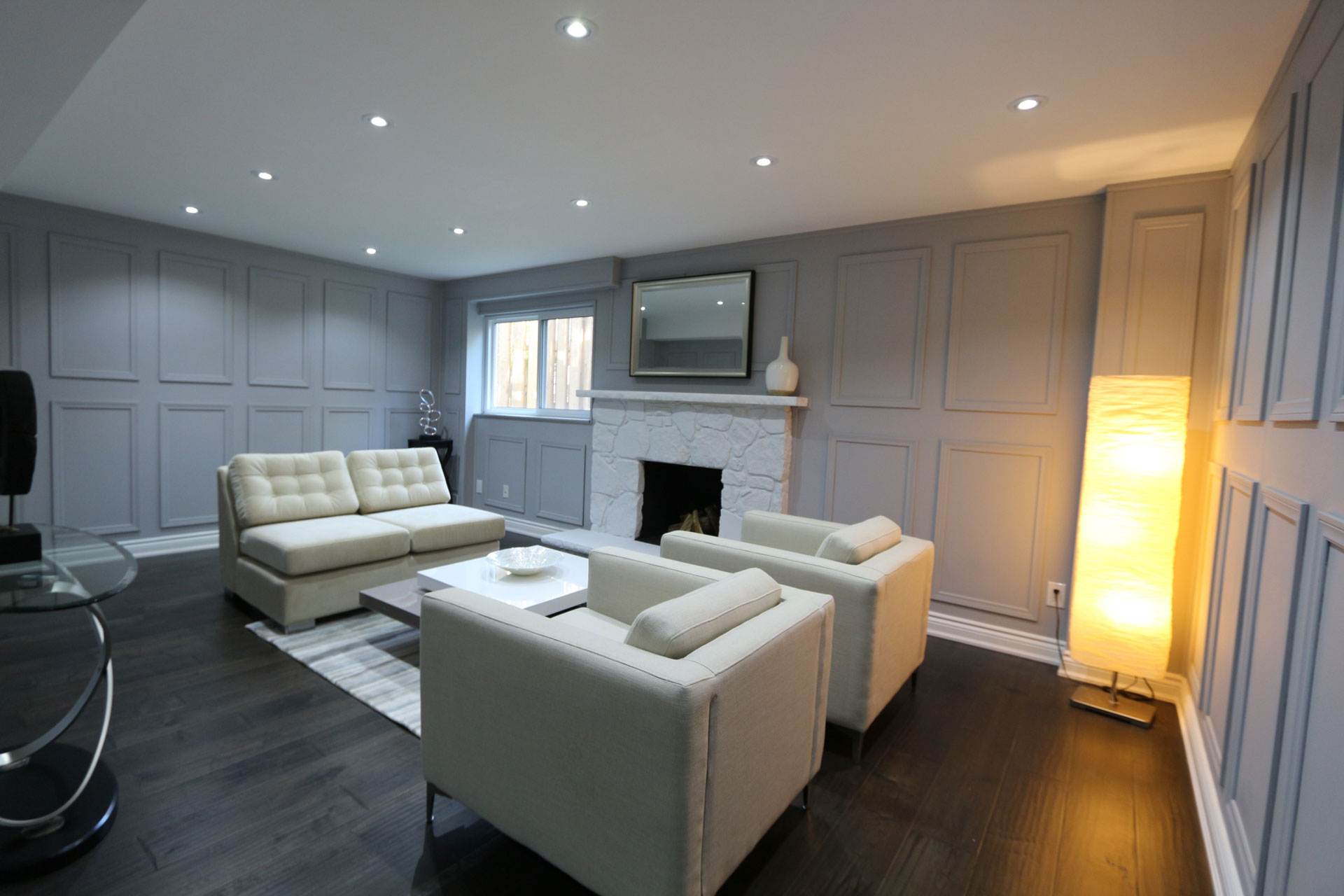 Modern Basement Family Room with Coffered Wall Decor - Basement Design Aurora